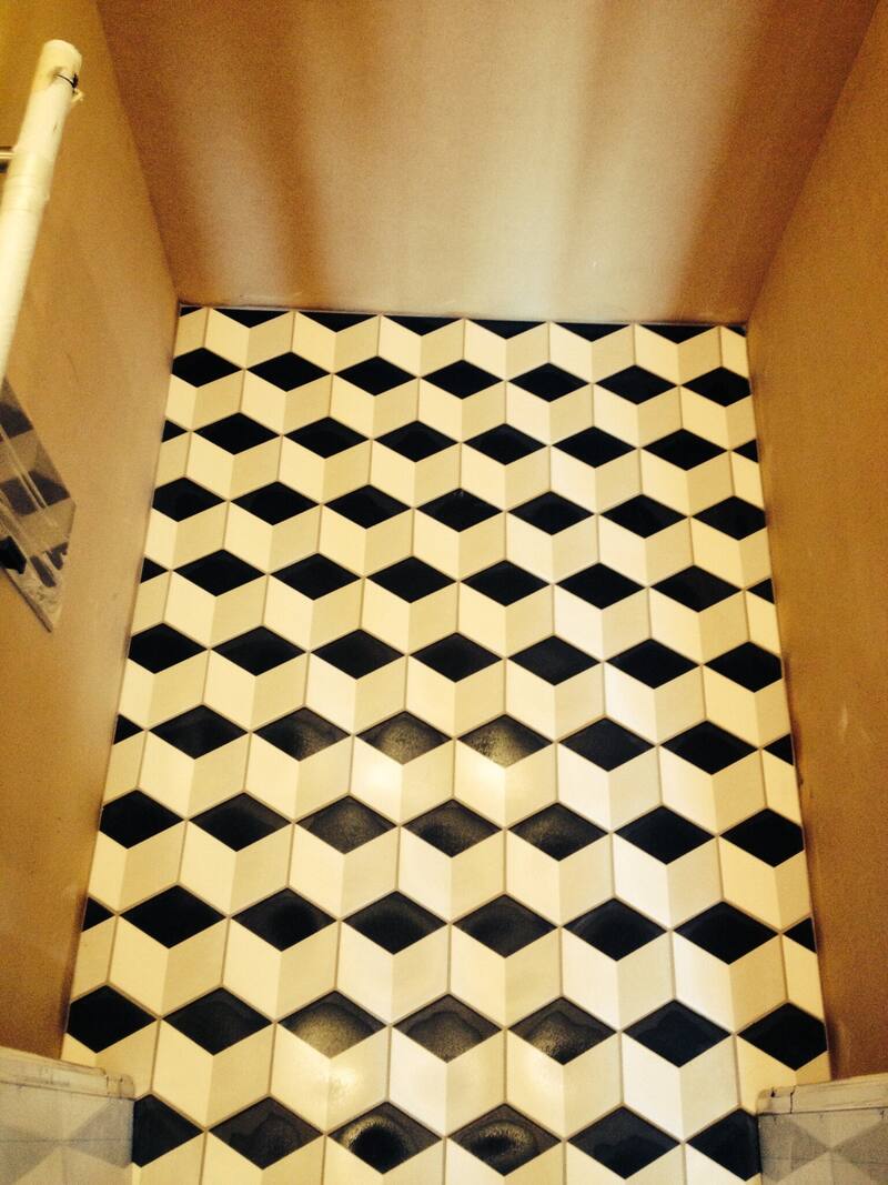 Black and white cube pattern floor tile in an elevator