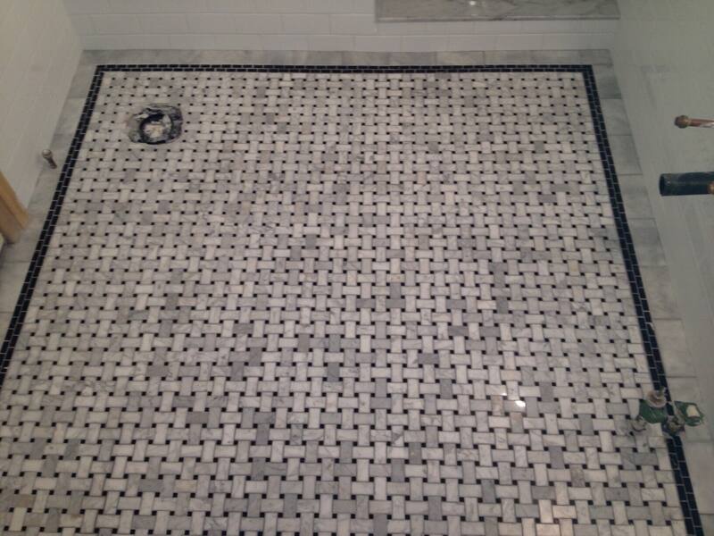 Basketweave mosaic bathroom floor with a navy blue border